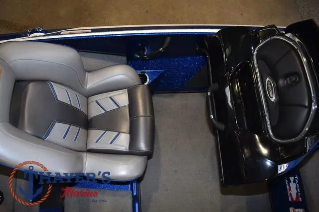 Slide: The Image of 2019 Nitro Z19 boat interior with gray and blue seating, steering console, and Thayer's Marine logo. - 19