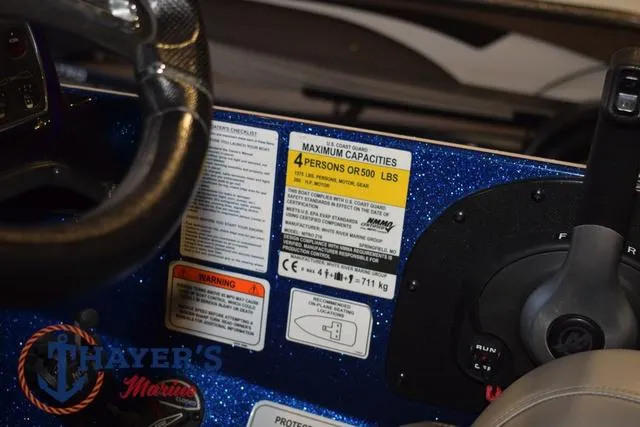 Slide: The Image of 2019 Nitro Z19 boat dashboard with capacity warning labels and steering wheel. - 20