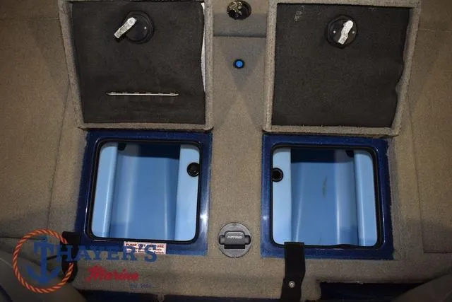 Slide: The Image of 2019 Nitro Z19 boat storage compartments with secure latches and blue interior. - 29
