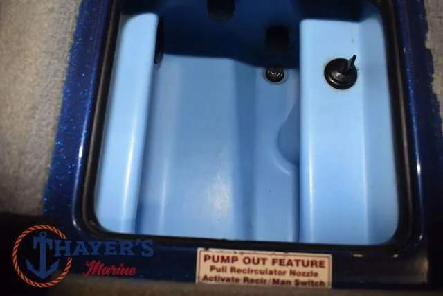 Slide: The Image of 2019 Nitro Z19 boat compartment with pump-out feature and Thayer's Marine logo. - 30