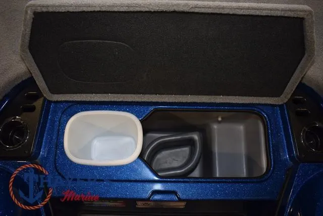Slide: The Image of 2019 Nitro Z19 boat storage compartment with open lid and containers. - 32