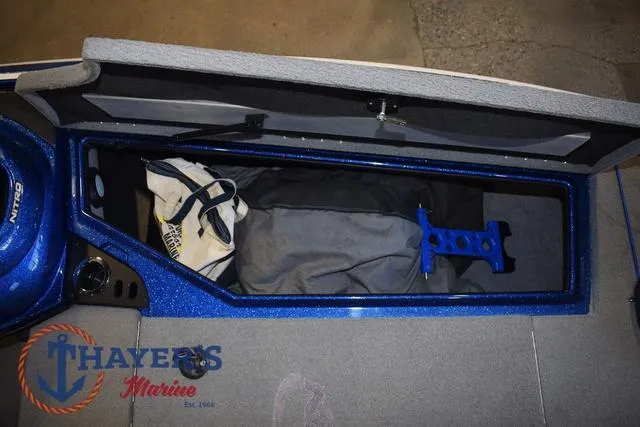 Slide: The Image of 2019 Nitro Z19 boat storage compartment with gear, Thayer's Marine logo visible. - 34