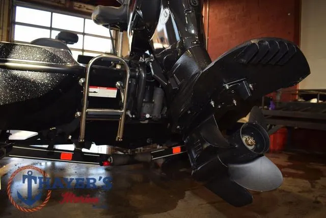 Slide: The Image of 2016 Stratos 176 VLO™ boat motor and propeller in a garage setting. - 9