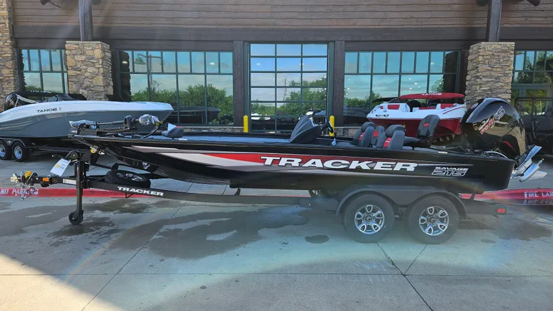 The Image of 2025 Tracker Savage 215 boat on trailer, parked outside a building. - 0