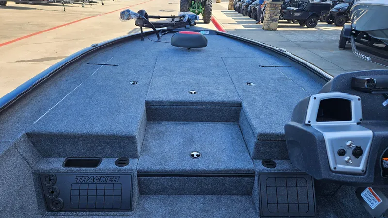Slide: The Image of 2025 Tracker Savage 215 boat interior with spacious deck and control panel. - 5