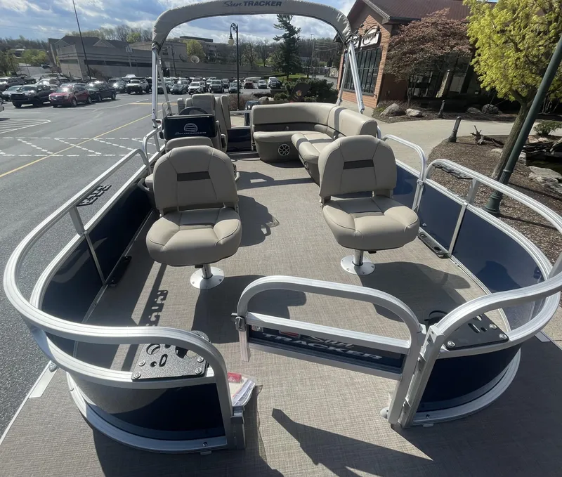 Slide: The Image of 2025 Sun Tracker Bass Buggy 16 XL Select pontoon boat with spacious seating and modern design. - 2
