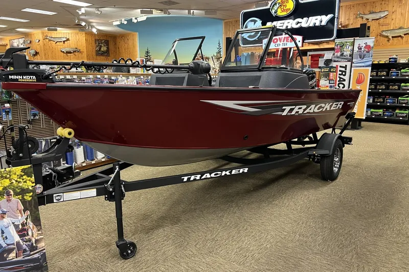 The Image of 2025 Tracker Pro Guide V-16 WT boat displayed in a showroom with accessories. - 0