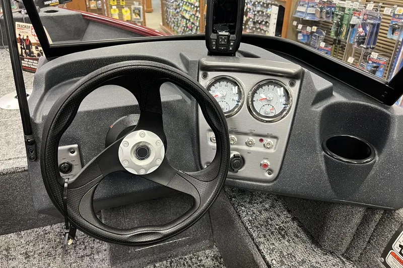 Slide: The Image of 2025 Tracker Pro Guide V-16 WT boat dashboard with steering wheel and gauges. - 4
