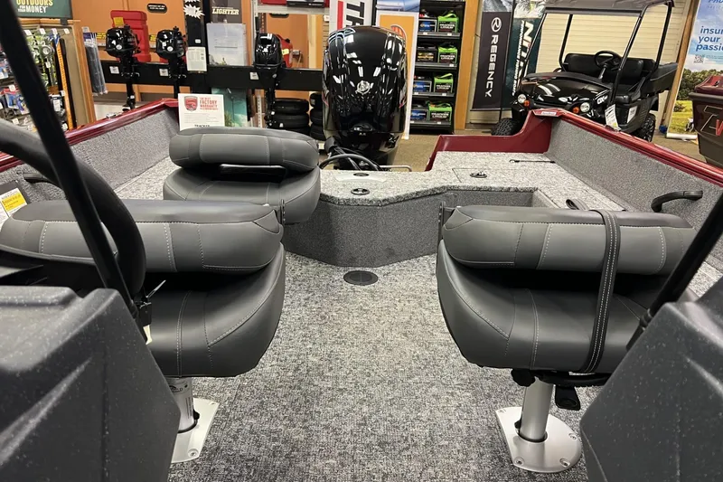 Slide: The Image of 2025 Tracker Pro Guide V-16 WT boat interior with gray seating and carpeted flooring. - 5