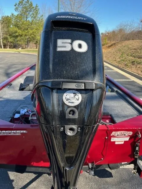 Slide: The Image of 2025 Tracker Pro 170 boat with Mercury 50 horsepower engine, parked outdoors. - 2