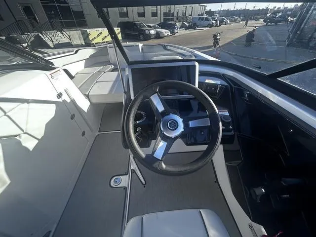Slide: The Image of 2023 Yamaha Boats AR250 cockpit with steering wheel and modern dashboard controls. - 11