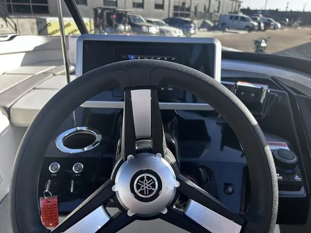 Slide: The Image of 2023 Yamaha AR250 boat dashboard with steering wheel and control panel. - 19