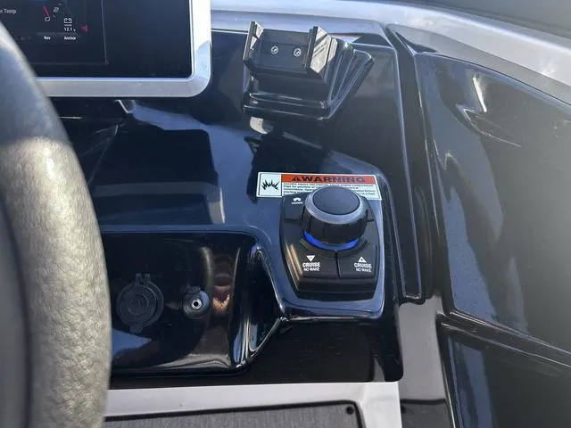 Slide: The Image of 2023 Yamaha AR250 boat dashboard with control panel and warning label. - 20