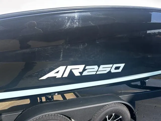 Slide: The Image of 2023 Yamaha Boats AR250, sleek black exterior, on trailer. - 3
