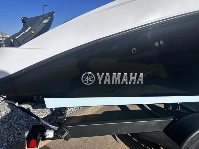 Slide: The Image of 2023 Yamaha AR250 boat side view with logo, on a trailer. - 4