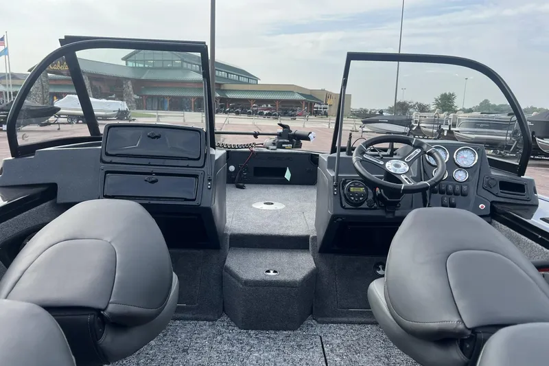 Slide: The Image of 2025 Tracker Targa V-18 Combo boat interior with steering wheel and seating. - 3