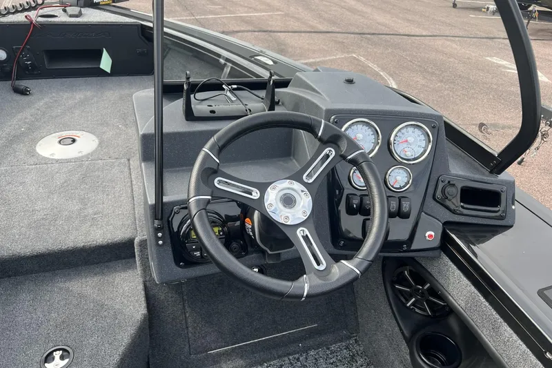 Slide: The Image of 2025 Tracker Targa V-18 Combo boat dashboard with steering wheel and gauges. - 4