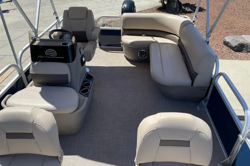 Slide: The Image of 2025 Sun Tracker Bass Buggy 16 XL Select pontoon boat interior with beige seating. - 5