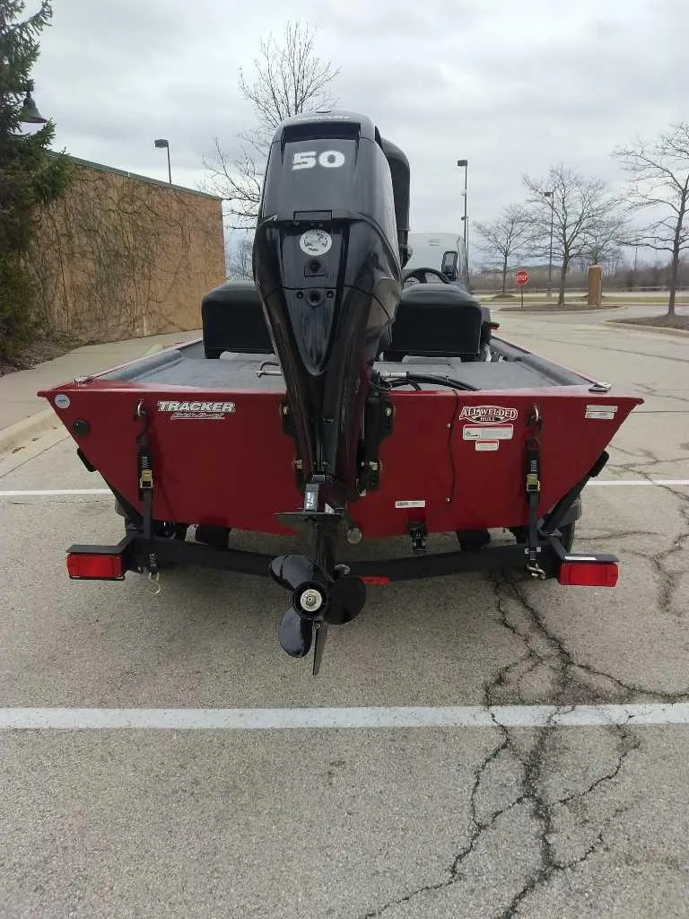 Slide: The Image of 2025 Tracker Bass Tracker Classic XL boat with 50 HP engine, parked outdoors. - 3