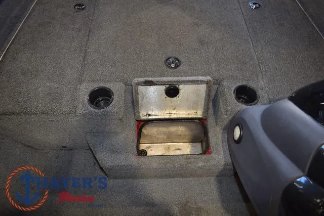 Slide: The Image of 2021 Tracker Pro Team 175 boat interior with storage compartment and carpeted flooring. - 18