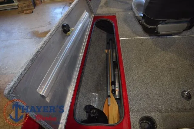 Slide: The Image of 2021 Tracker Pro Team 175 boat storage compartment with fishing rod holder. - 20