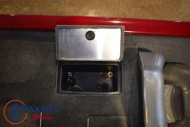 Slide: The Image of 2021 Tracker Pro Team 175 boat storage compartment with gray interior and red trim. - 24