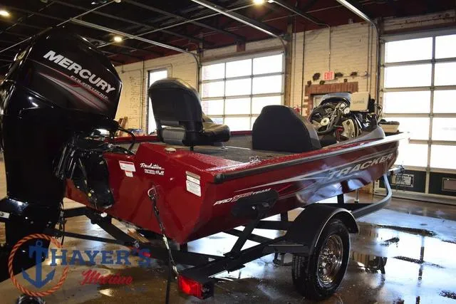 Slide: The Image of 2021 Tracker Pro Team 175 boat with Mercury engine in showroom. - 3