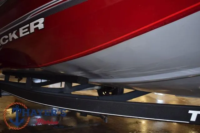 Slide: The Image of 2021 Tracker Pro Team 175 boat on trailer, red and gray hull, Thayer's Marine logo visible. - 31