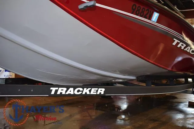 Slide: The Image of 2021 Tracker Pro Team 175 boat on trailer, red and white hull, Thayer's Marine logo visible. - 32