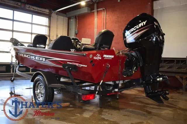 Slide: The Image of 2021 Tracker Pro Team 175 boat with Mercury engine in a garage setting. - 4