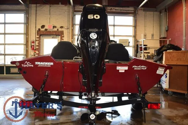 Slide: The Image of 2021 Tracker Pro Team 175 boat, red, rear view in a garage setting. - 9