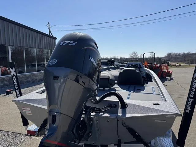 Slide: The Image of 2025 Xpress H20 boat with Yamaha 175 engine, parked outdoors. - 2