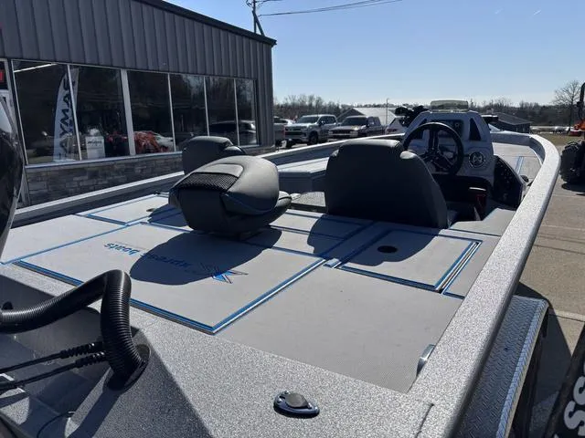 Slide: The Image of 2025 Xpress H20 boat with sleek design, parked outside a showroom. - 4