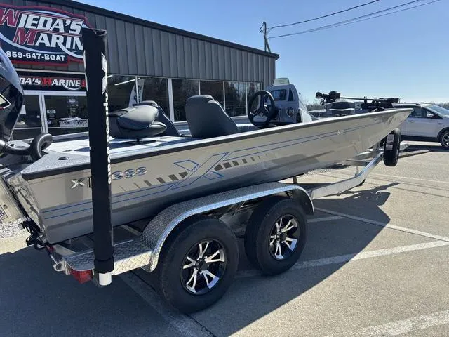 Slide: The Image of 2025 Xpress H20 boat on trailer at dealership parking lot. - 5