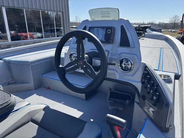 Slide: The Image of 2025 Xpress H20 boat dashboard with steering wheel and control panel. - 6