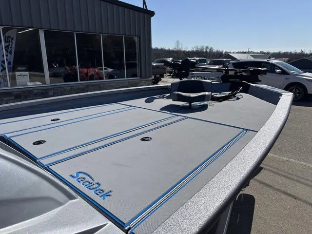 Slide: The Image of 2025 Xpress H20 boat with SeaDek flooring, parked outside a showroom. - 8