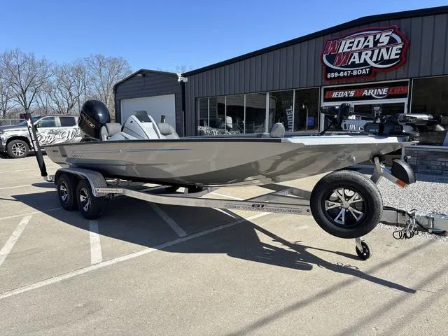 Slide: The Image of 2025 Xpress H20 boat on trailer outside dealership, sunny day. - 9