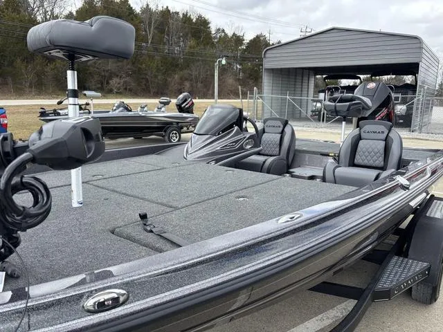Slide: The Image of 2025 Caymas CX 20 PRO boat with dual seats and trolling motor, parked outdoors. - 13