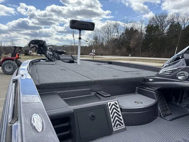 Slide: The Image of 2025 Caymas CX 20 PRO boat deck with storage compartments, under a partly cloudy sky. - 17