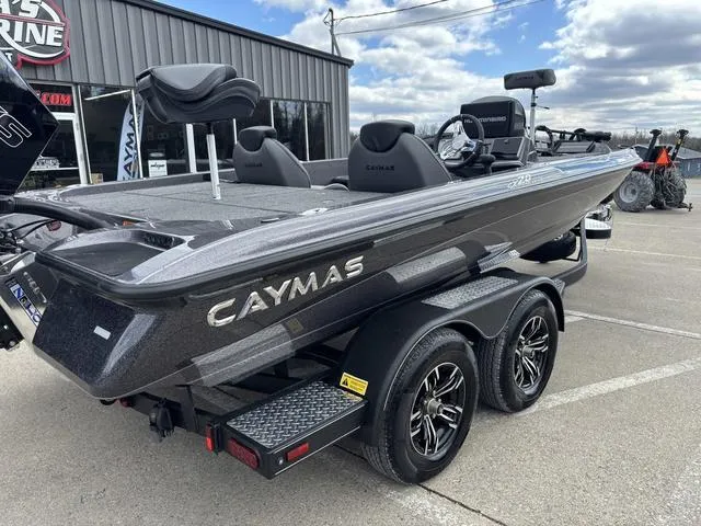 Slide: The Image of 2025 Caymas CX 20 PRO boat on trailer, parked outdoors, showcasing sleek design and dual axles. - 5