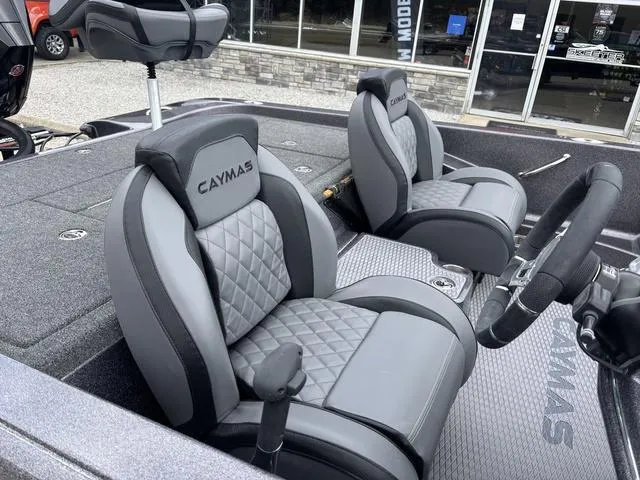 Slide: The Image of 2025 Caymas CX 20 PRO boat interior with gray quilted seats and steering wheel. - 7