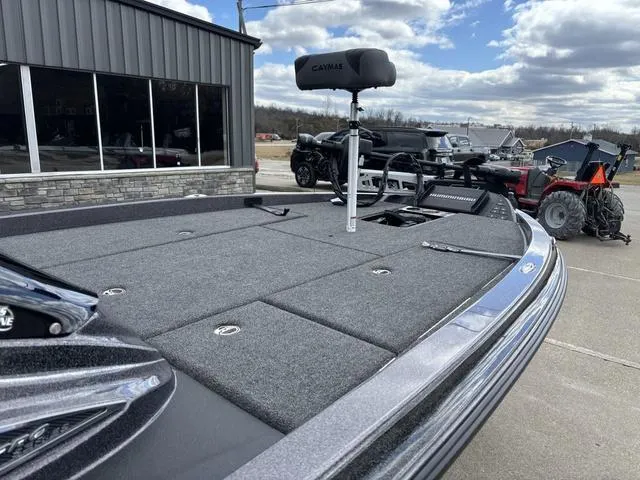 Slide: The Image of 2025 Caymas CX 20 PRO boat with spacious deck, parked outdoors under cloudy sky. - 8