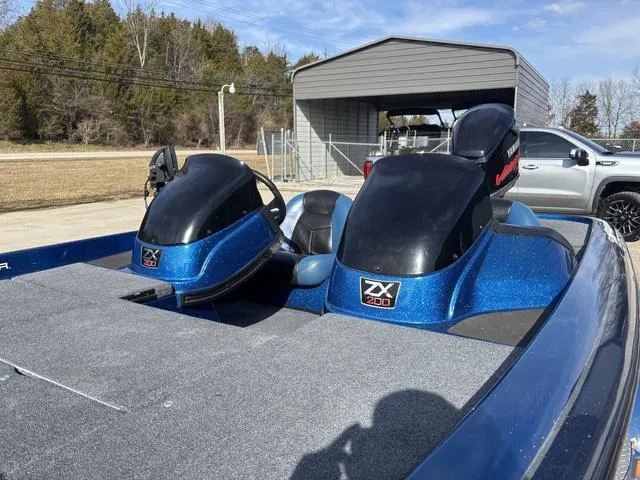 Slide: The Image of 2008 Skeeter ZX200 boat with blue accents parked outdoors. - 11
