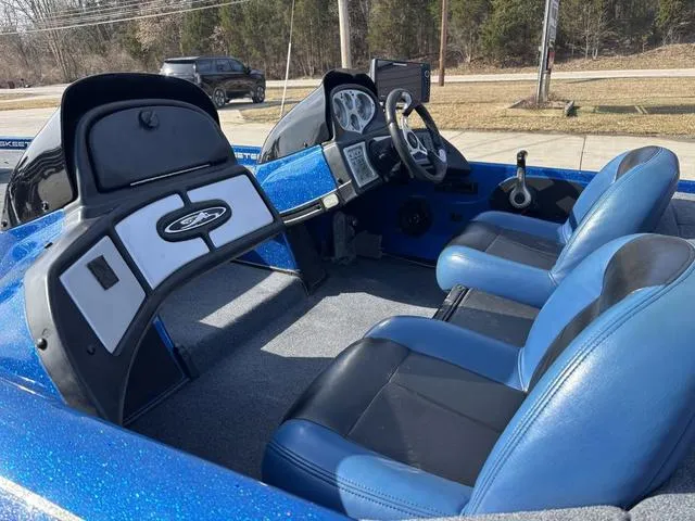 Slide: The Image of 2008 Skeeter ZX200 boat interior with blue and black seats, dashboard, and steering wheel. - 12