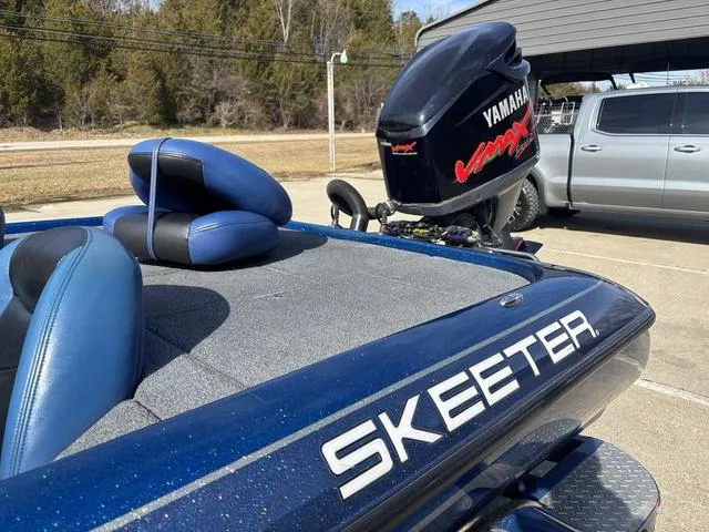 Slide: The Image of 2008 Skeeter ZX200 boat with Yamaha VMAX engine, parked outdoors. - 13