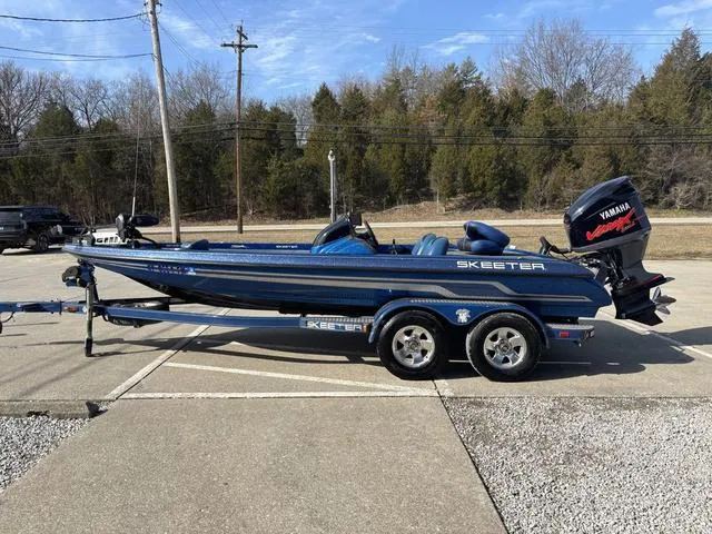 Slide: The Image of 2008 Skeeter ZX200 boat with Yamaha engine on trailer, parked outdoors. - 14