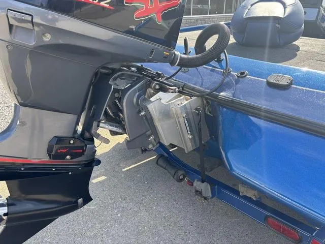 Slide: The Image of 2008 Skeeter ZX200 boat with outboard motor, blue hull, and visible engine components. - 3