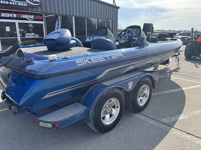 Slide: The Image of 2008 Skeeter ZX200 blue fishing boat on trailer, parked outside dealership. - 5