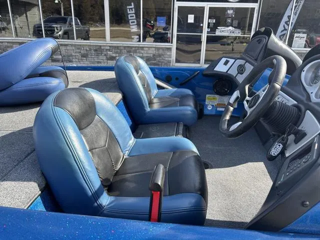 Slide: The Image of 2008 Skeeter ZX200 boat interior with blue and black seats, steering wheel, and dashboard. - 6