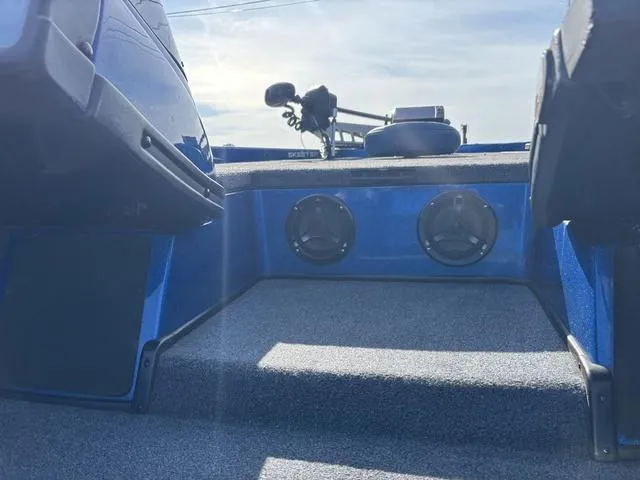 Slide: The Image of 2008 Skeeter ZX200 boat interior with speakers and carpeted flooring. - 7